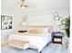 Bright main bedroom featuring neutral tones, ceiling fan, nightstands, a window, and an accent wall design at 1112 Montezuma Dr, Bradenton, FL 34209