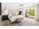 Spacious main bedroom with ceiling fan, decor, deck access, and plenty of natural light at 1112 Montezuma Dr, Bradenton, FL 34209