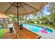 Outdoor pool featuring an attached tiki bar with chairs and festive floaties at 1112 Montezuma Dr, Bradenton, FL 34209