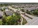 Aerial view of home in a beautiful neighborhood featuring mature landscaping and a community lake at 11434 Spring Gate Trl, Bradenton, FL 34211