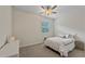 Bright bedroom with a ceiling fan, neutral decor, and a window with shutters at 11434 Spring Gate Trl, Bradenton, FL 34211