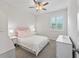 Bright bedroom with a ceiling fan, shuttered window, and two bedside tables and lamps at 11434 Spring Gate Trl, Bradenton, FL 34211