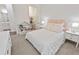 Cozy bedroom featuring a decorative headboard, plush carpet, and a charming bookcase at 11434 Spring Gate Trl, Bradenton, FL 34211