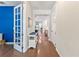 Hallway with hardwood floors, white walls, and stylish decor leading to other rooms at 11434 Spring Gate Trl, Bradenton, FL 34211