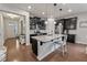 Bright kitchen featuring an island with bar seating, pendant lighting, and stainless appliances under dark cabinets at 11434 Spring Gate Trl, Bradenton, FL 34211