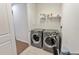 Convenient laundry room with modern washer and dryer and wire shelving for storage at 11434 Spring Gate Trl, Bradenton, FL 34211