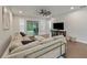 Spacious living room with a large sectional sofa, ceiling fan, and sliding glass doors leading to the outside at 11434 Spring Gate Trl, Bradenton, FL 34211