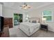 Bright bedroom with a ceiling fan, plush carpeting, and access to a screened-in patio at 11434 Spring Gate Trl, Bradenton, FL 34211