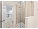 Modern shower featuring glass enclosure and light tile, connected to hallway and other rooms at 11434 Spring Gate Trl, Bradenton, FL 34211