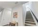 Carpeted staircase with modern railings and a stylish console table with mirror accent at 11434 Spring Gate Trl, Bradenton, FL 34211