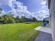 Spacious backyard with a trampoline, lush lawn, and scenic views of the surrounding landscape at 12832 Oak Hill Way, Parrish, FL 34219