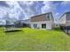 Expansive backyard featuring a lush lawn, trampoline, and fenced perimeter for privacy and security at 12832 Oak Hill Way, Parrish, FL 34219