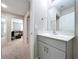 Bathroom featuring a white vanity with gray cabinets and views into the living room at 12832 Oak Hill Way, Parrish, FL 34219