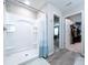 Bright bathroom featuring a white shower with blue-ombre curtain and neutral walls at 12832 Oak Hill Way, Parrish, FL 34219