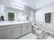 Well-lit bathroom with double sinks, quartz countertops, and modern fixtures at 12832 Oak Hill Way, Parrish, FL 34219
