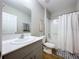 Bright bathroom featuring a shower-tub combo, modern vanity, and wood-look tile floors at 12832 Oak Hill Way, Parrish, FL 34219