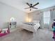 Comfortable bedroom with a rainbow theme, ceiling fan, and a rainbow nightlight at 12832 Oak Hill Way, Parrish, FL 34219