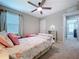 Comfortable bedroom with a rainbow theme, ceiling fan, and plenty of natural light at 12832 Oak Hill Way, Parrish, FL 34219