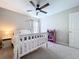 Comfortable bedroom with a rainbow theme, ceiling fan, and a purple wardrobe at 12832 Oak Hill Way, Parrish, FL 34219