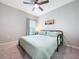Well-lit bedroom featuring neutral tones, a queen-sized bed, and a ceiling fan for optimal airflow at 12832 Oak Hill Way, Parrish, FL 34219