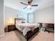 Comfortable bedroom with a wooden bed frame, a desk, ceiling fan and a window at 12832 Oak Hill Way, Parrish, FL 34219