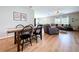 Open-concept dining area with a modern table and chairs, flowing into a living room with a plush gray sectional at 12832 Oak Hill Way, Parrish, FL 34219