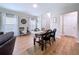 Bright dining area featuring wood floors, a stylish table with four chairs, and natural light from two windows at 12832 Oak Hill Way, Parrish, FL 34219
