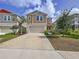 Inviting two-story home boasts a manicured front lawn, two-car garage, and a vibrant blue sky backdrop at 12832 Oak Hill Way, Parrish, FL 34219