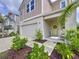 Charming two-story home featuring a well-maintained lawn, two-car garage, and welcoming front porch with rocking chair at 12832 Oak Hill Way, Parrish, FL 34219