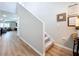 Bright hallway featuring hardwood floors, stairway, and view into the open-concept living room at 12832 Oak Hill Way, Parrish, FL 34219