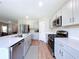 Well-lit kitchen featuring stainless steel appliances, light gray cabinetry, and a spacious open layout at 12832 Oak Hill Way, Parrish, FL 34219