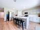 Bright kitchen features a large island with bar seating, stainless steel appliances, and contemporary cabinetry at 12832 Oak Hill Way, Parrish, FL 34219