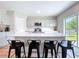 Modern kitchen boasts an island with seating, stainless steel appliances, and ample counter space at 12832 Oak Hill Way, Parrish, FL 34219