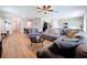 Spacious living room with hardwood floors, ceiling fan, and comfortable sectional sofa perfect for entertaining at 12832 Oak Hill Way, Parrish, FL 34219