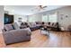 Bright living room features hardwood floors, comfortable seating, and large windows providing natural light at 12832 Oak Hill Way, Parrish, FL 34219