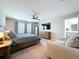 Bright main bedroom featuring a king-sized bed, ceiling fan, and large windows for natural light at 12832 Oak Hill Way, Parrish, FL 34219