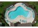Aerial view of a community pool surrounded by lounge chairs and lush landscaping at 12832 Oak Hill Way, Parrish, FL 34219