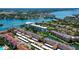 An aerial view features the property's canal access, boat mooring, and community pool at 1300 N Portofino Dr # 103, Sarasota, FL 34242