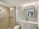 Clean bathroom with a glass-enclosed shower, updated vanity, and modern fixtures at 1300 N Portofino Dr # 103, Sarasota, FL 34242