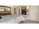 The bedroom is light and airy with a modern built-in entertainment center and comfortable queen size bed at 1300 N Portofino Dr # 103, Sarasota, FL 34242
