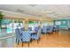 Community clubhouse featuring tables, chairs, and sliding glass doors leading to a pool area at 1300 N Portofino Dr # 103, Sarasota, FL 34242