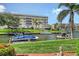 The property features lush landscaping, and serene canal views with boat mooring at 1300 N Portofino Dr # 103, Sarasota, FL 34242