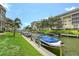 Beautiful canal view of property featuring well maintained grassy areas and boat docks at 1300 N Portofino Dr # 103, Sarasota, FL 34242