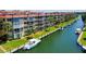 Waterfront condos with a boat slip, featuring lush landscaping and direct access to beautiful waterways at 1300 N Portofino Dr # 103, Sarasota, FL 34242