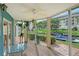 The lanai features glass windows, wood flooring, and great views of the canal at 1300 N Portofino Dr # 103, Sarasota, FL 34242