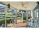 Enclosed lanai with glass top table offering beautiful views of the canal and adjacent landscaping at 1300 N Portofino Dr # 103, Sarasota, FL 34242