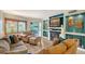 Living room with plush seating, a fireplace, and a sliding glass door leading to the outside at 1300 N Portofino Dr # 103, Sarasota, FL 34242