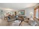 Comfortable living room featuring a large sectional sofa, a dining area, and a modern light fixture at 1300 N Portofino Dr # 103, Sarasota, FL 34242