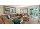 Cozy living room with comfortable seating, a large window, and sliding glass door for natural light at 1300 N Portofino Dr # 103, Sarasota, FL 34242