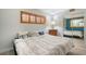 Comfortable bedroom featuring wood-look floors, a cozy bed, and a large window at 1300 N Portofino Dr # 103, Sarasota, FL 34242